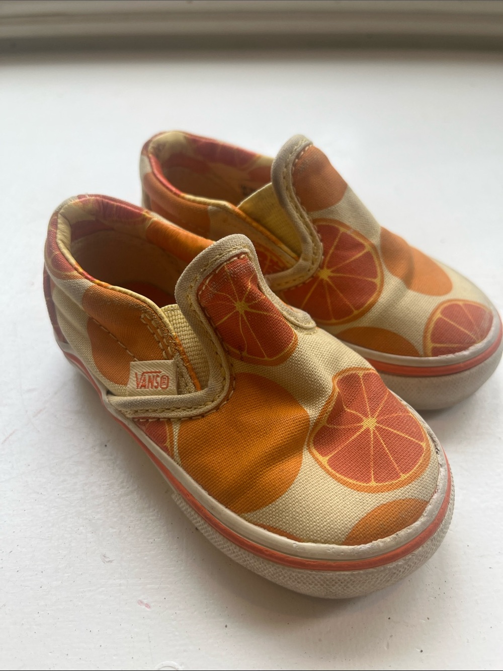 Vans Kids Slip-On Sneakers in Orange and Cream Citrus Print